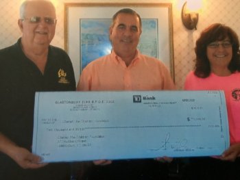 TJ Quinn (center) accepting generous donation from the Glastonbury Elks Club